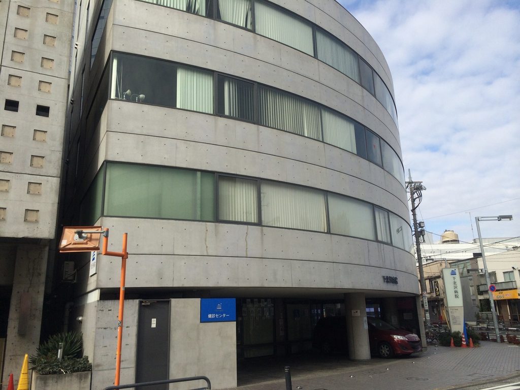 斜め方向から見た旧福原病院の曲面外壁と連続窓 / Curved concrete façade and continuous glazing of the former Fukuhara Hospital viewed obliquely