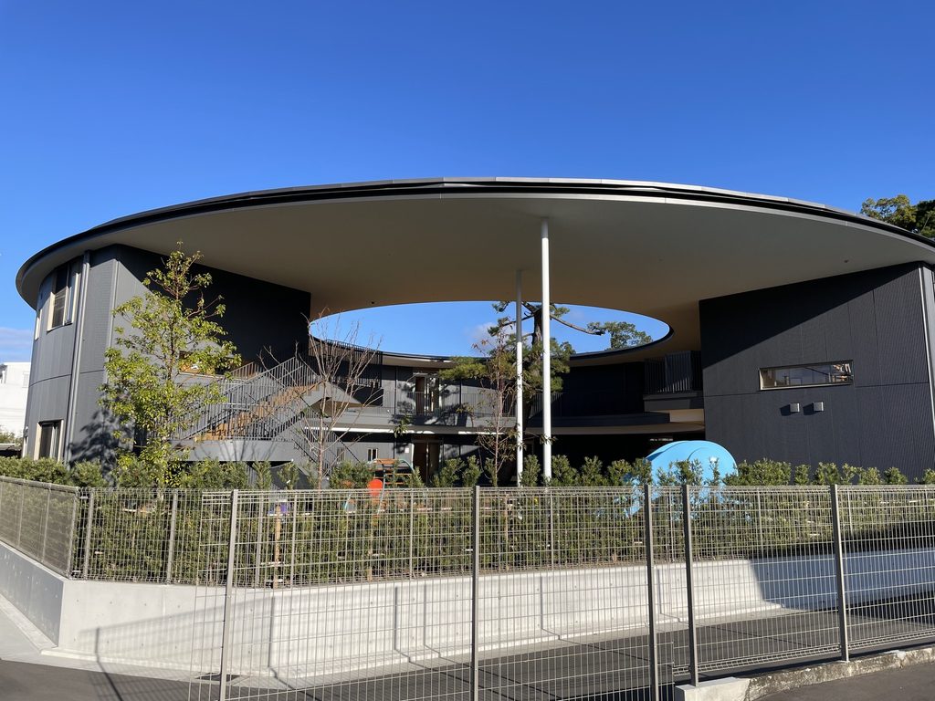 大きな円形屋根と中央の開口が見える認定こども園五風会の外観 / Exterior of Gofukai with its large circular roof and central opening