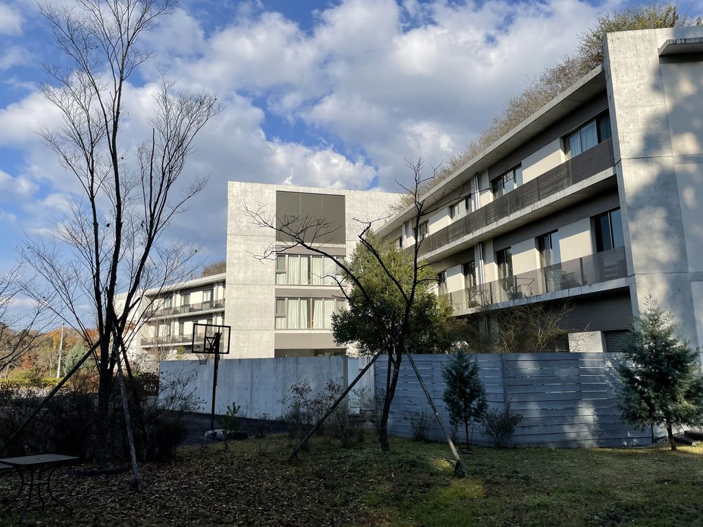 樹木の間から見るハートウィングの複数の住棟 / Multiple residential wings of HEART WING seen among trees