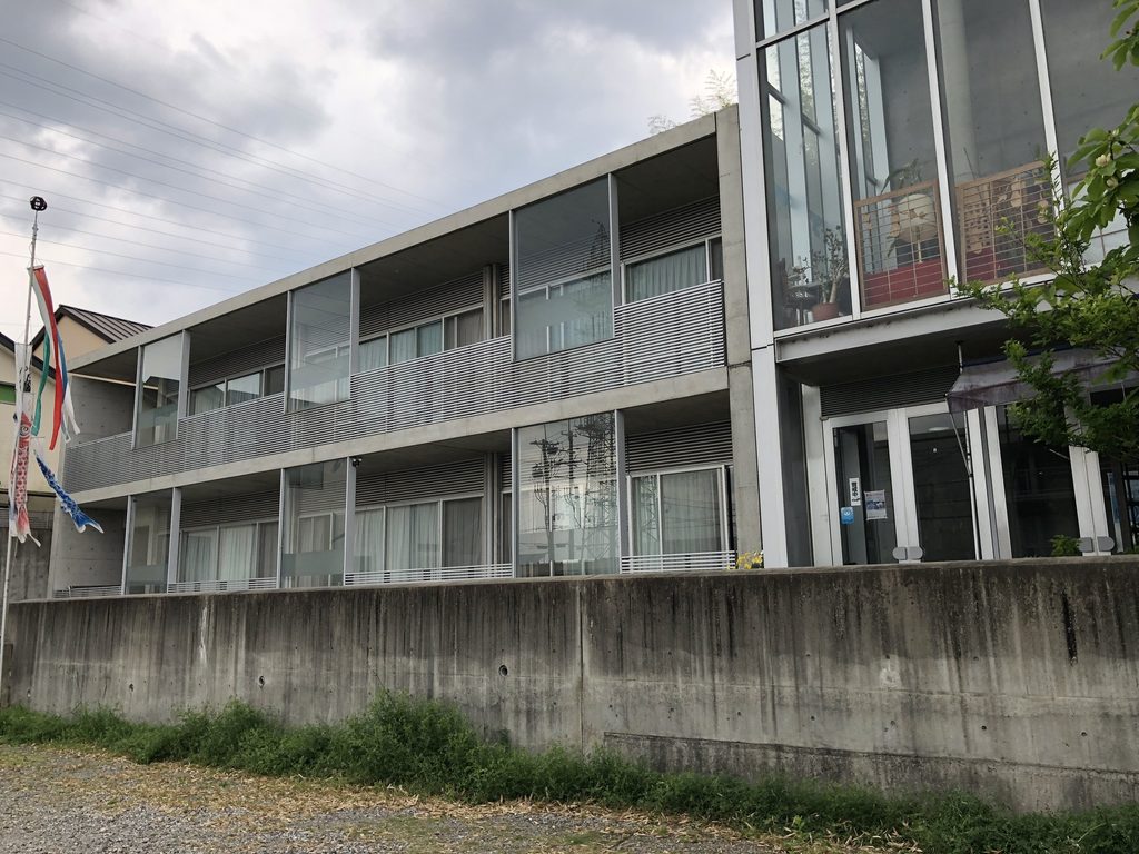ガラスとバルコニーが連続する洛和グループホーム大山崎の居室側外観 / Residential elevation of Rakuwa Group Home Oyamazaki with glazing and balconies